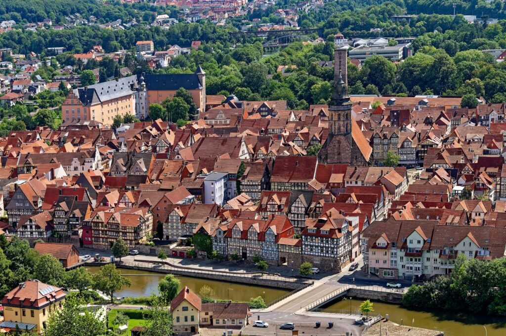Aerial view of Hann. Münden's charming, historic rooftops and lush greenery.