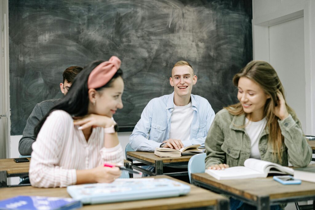 Group of teenagers actively participating in a classroom setting, focusing on their studies.